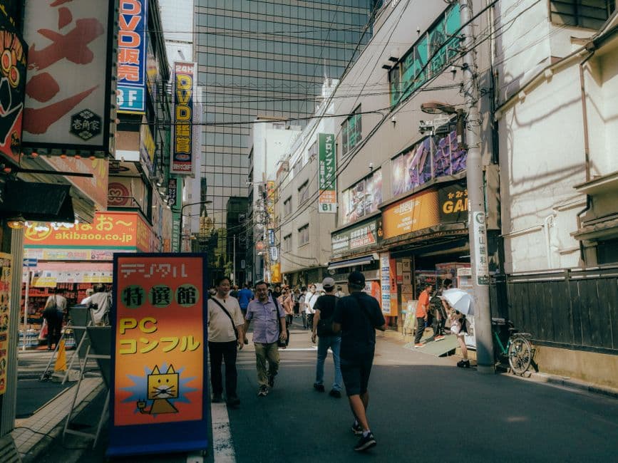 Gente caminando por una calle en una ciudad japonesa, en la sala de chat de Dragon Ball GT