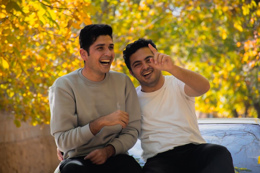 Dos hombres sentados, riendo y charlando animadamente, en el chat de Tapatíos