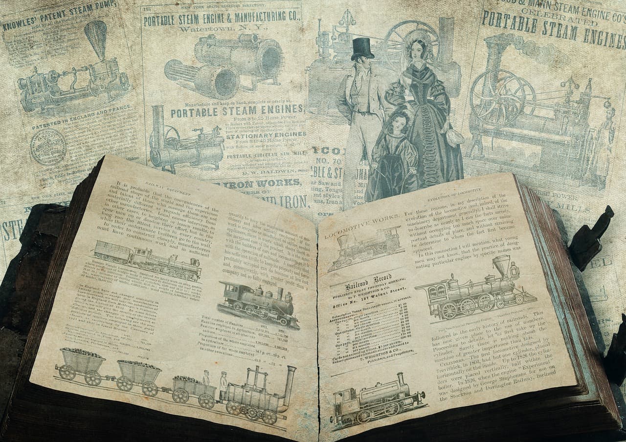Máquinas de vapor junto a un libro sobre una mesa
