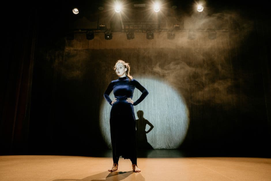 woman in velvet dress performing on stage