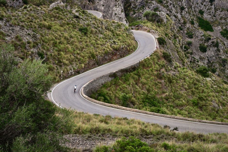 Vista aérea de persona en bicicleta en carretera de montaña