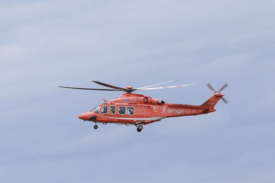 Un helicóptero rojo en vuelo contra el cielo