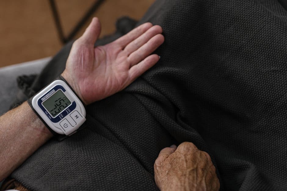 Una persona midiendo su presión arterial con un tensiómetro