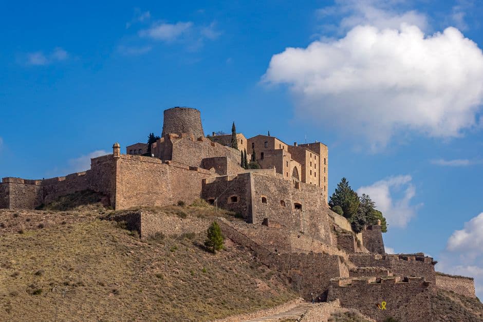 Castillo de Cardona visto desde lejos, con cielo azul y vegetación, en el chat de Castellbisbal
