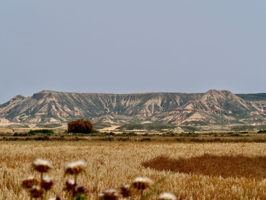 Paisaje desértico de Bardenas Reales con formaciones rocosas y cielo claro, en el chat de Aranguren