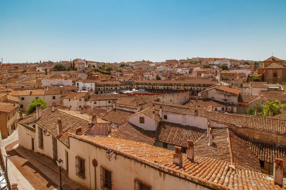 Edificios con tejas rojas y blancas bajo cielo claro, en el chat de Lucena