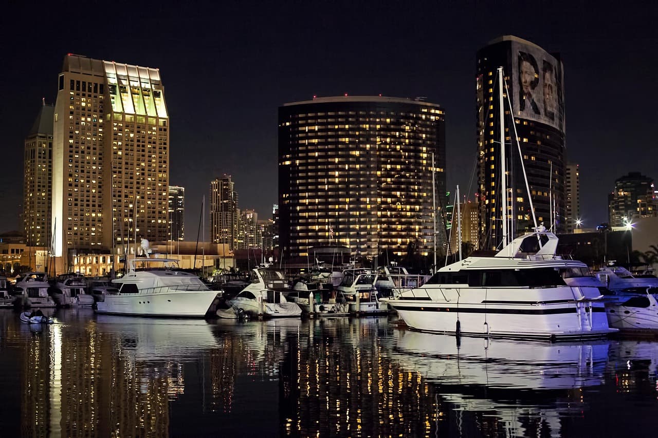 Panorama nocturno de la ciudad con barcos y yates, en el chat de San Diego de la Unión
