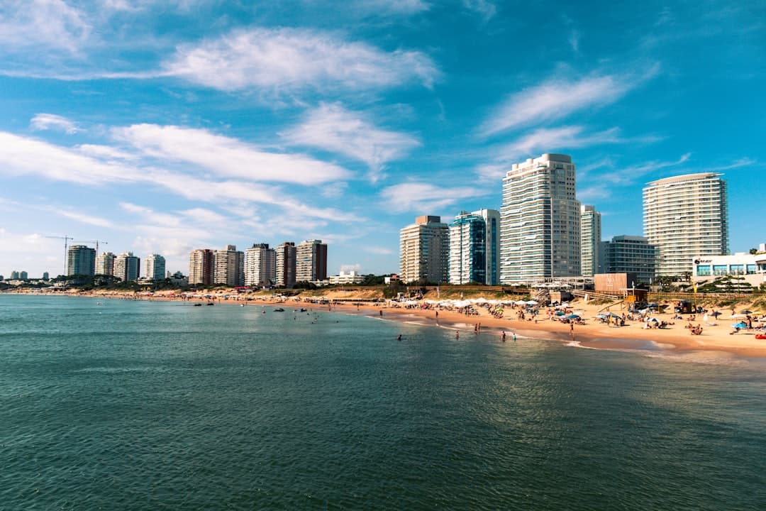 Edificios altos frente al mar bajo cielo azul, en el chat de Punta del Este