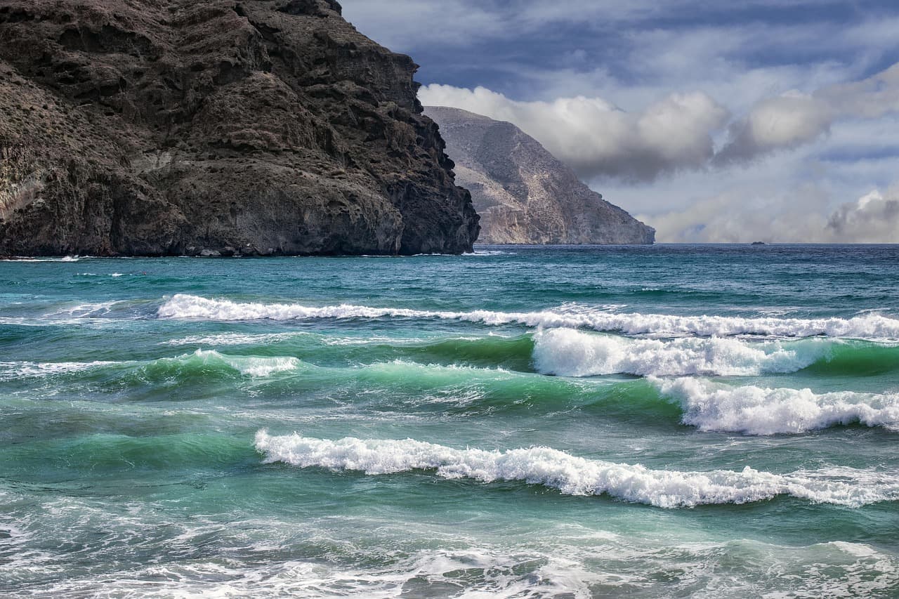 Playa con rocas y olas rompiendo en la costa, en el chat de Alhama de Almería