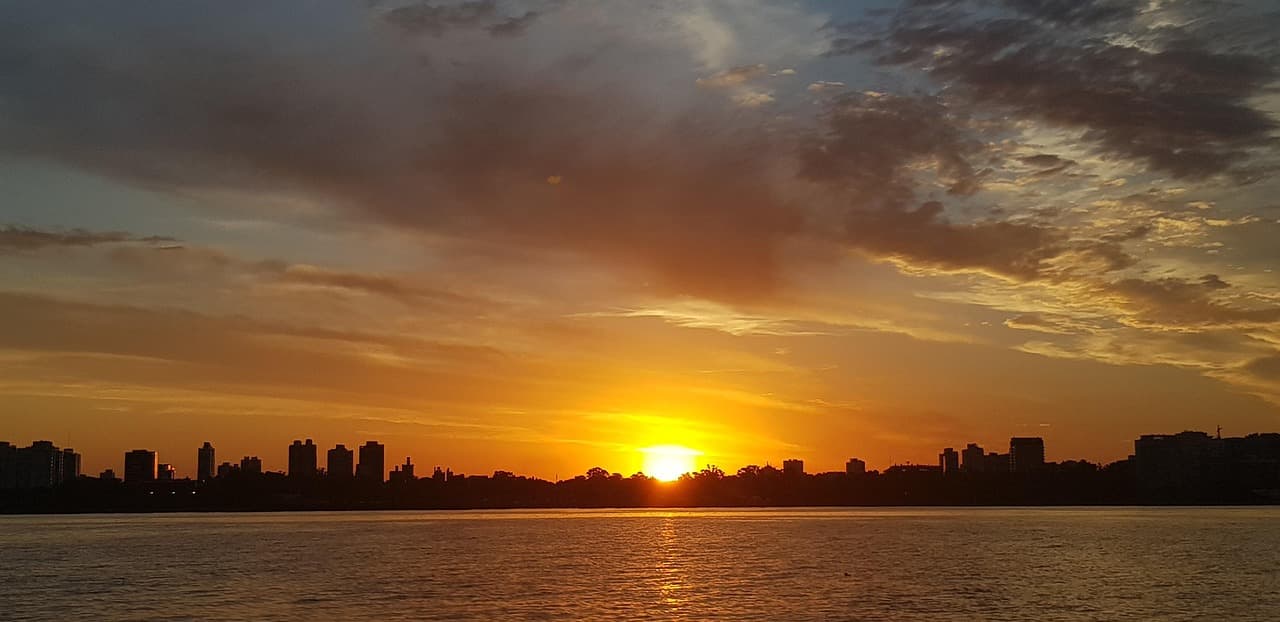 Silueta de una gran ciudad al atardecer, en el chat de San José (Almirante Brown)