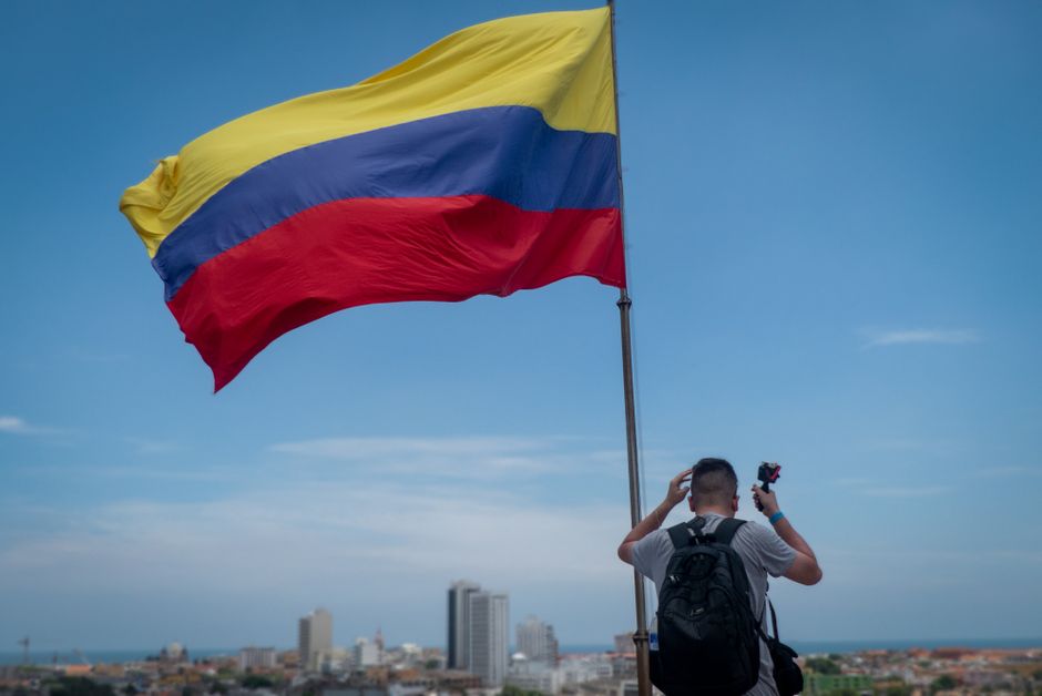 Hombre bajo una bandera ondeante, mirando al horizonte, en la sala de chat de Soledad