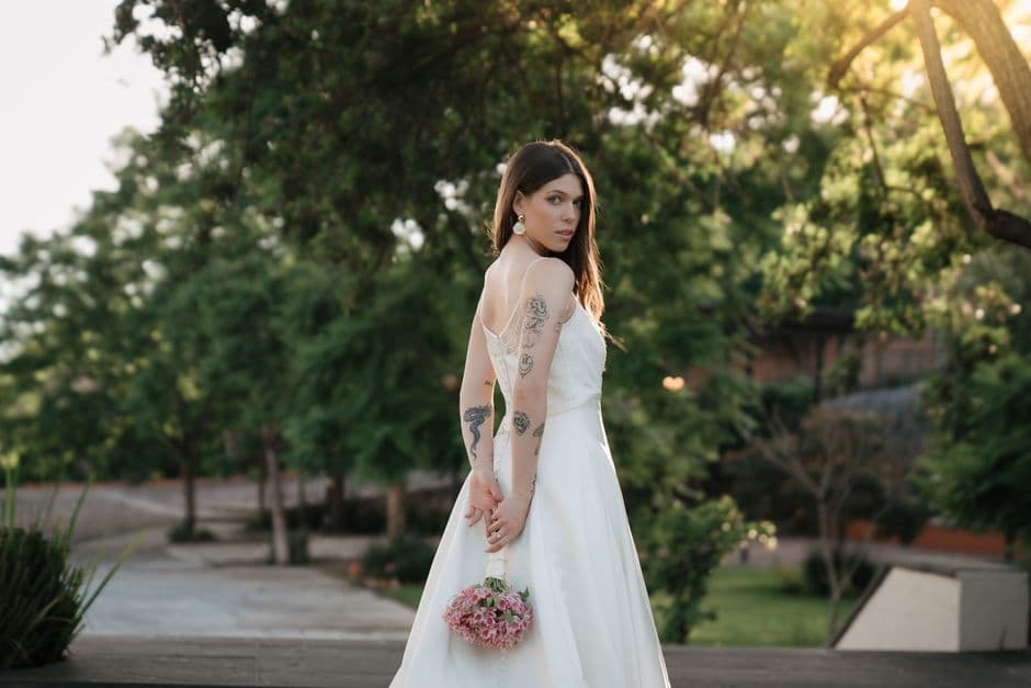 Una novia con vestido de bodas parada bajo el sol, en el chat de Santiago de Chuco
