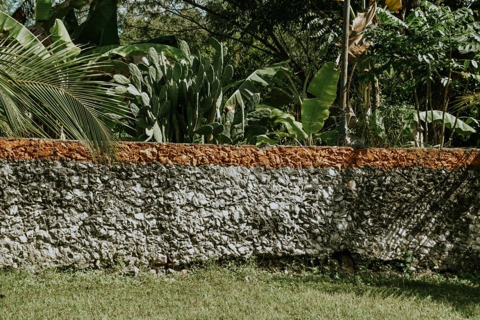 Muro de piedra al sol en un jardín, en el chat de El Cercado