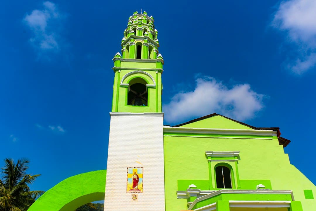 Edificio verde y blanco con torre de reloj, en el chat de Huehuetla
