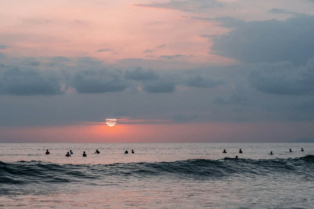 Personas surfeando las olas del mar de día, en el chat de Jacó