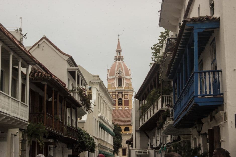 Iglesia de tonos beige y marrón junto a otros edificios, en el chat de Gamarra
