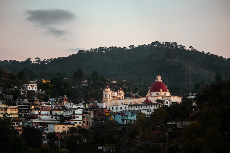 Edificios de concreto cerca de una montaña, en la sala de chat de Santa Catarina