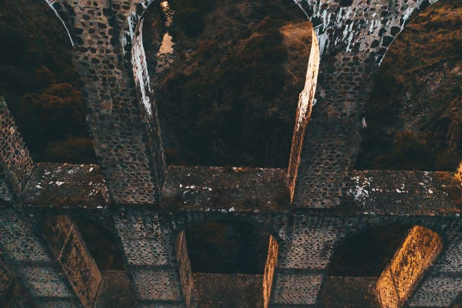 Puente de concreto marrón sobre río bajo cielo azul, en la sala de chat de Durango