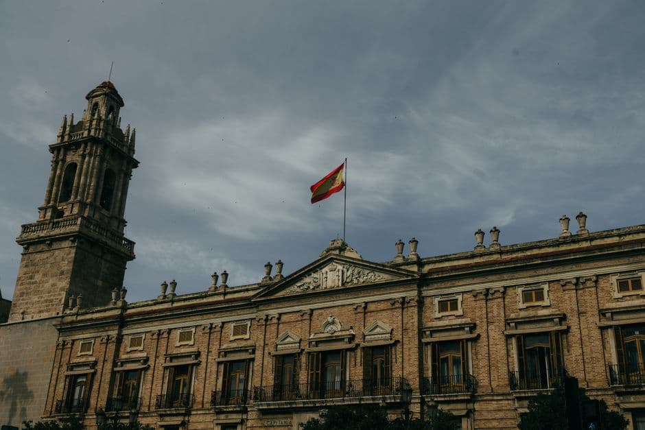 Edificio histórico con bandera española en la sala de chat de Sagunto