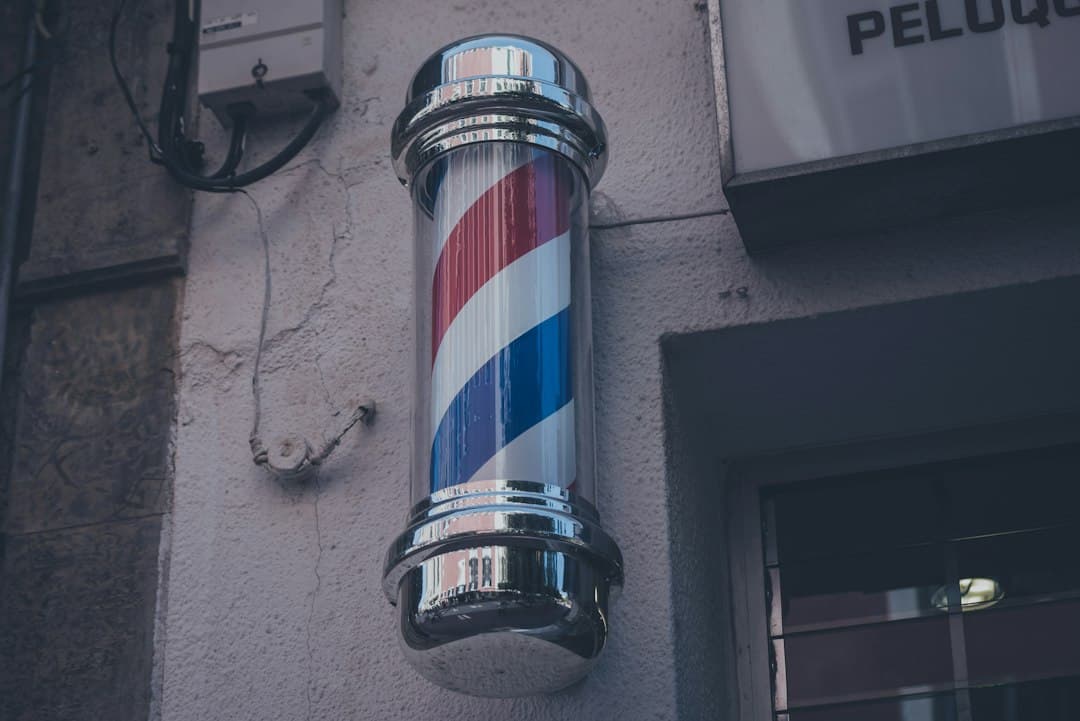Cartel de una barbería sobre una pared gris, en el chat de Mahón
