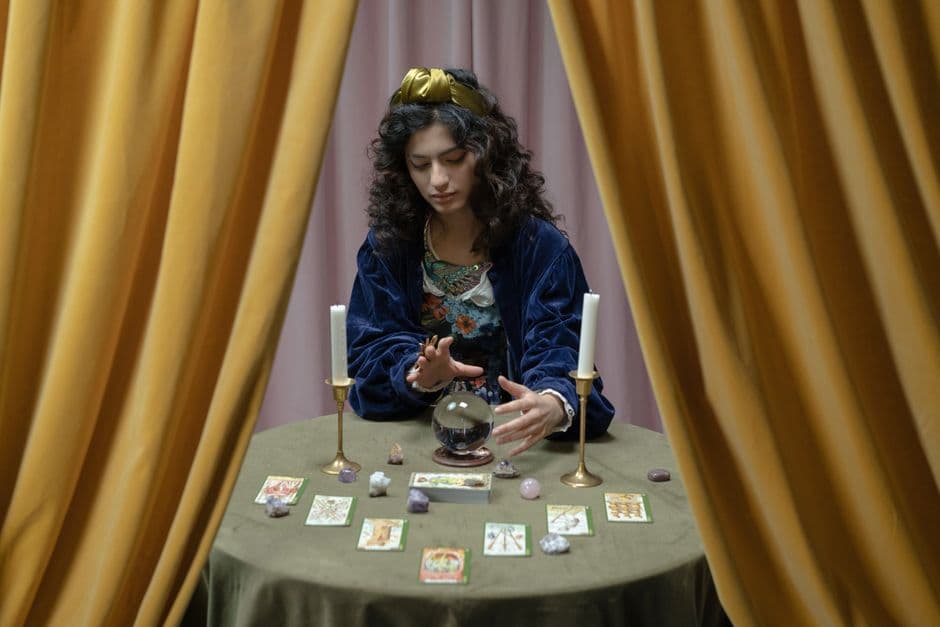 Mujer leyendo tarot y observando una bola de cristal, en la sala de chat de Hechizos