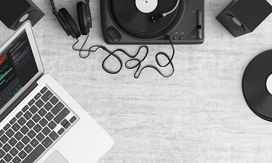 MacBook Pro y audífonos negros sobre mesa gris, en la sala de chat de Alternativo